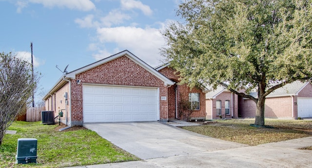 view of front of home with a garage and central AC