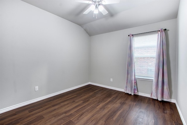 unfurnished room featuring lofted ceiling, a healthy amount of sunlight, ceiling fan, and dark wood-type flooring