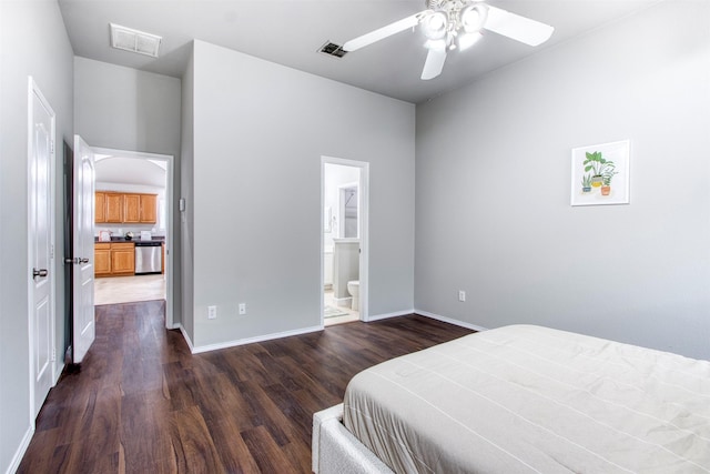 bedroom featuring ceiling fan, connected bathroom, and dark hardwood / wood-style floors