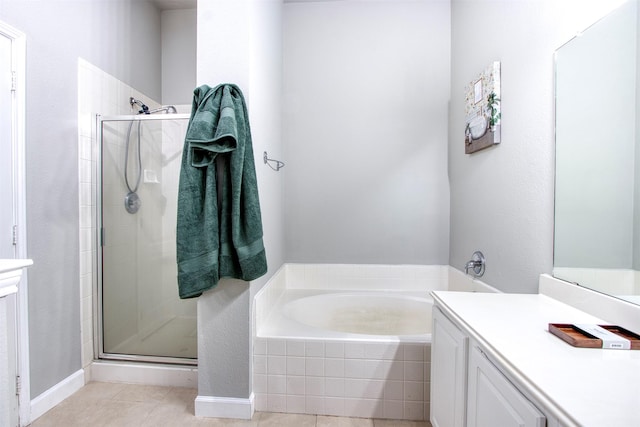 bathroom featuring shower with separate bathtub, tile patterned floors, and vanity