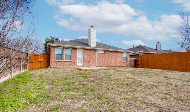 rear view of property with a patio area and a lawn