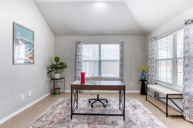 tiled office featuring lofted ceiling and a healthy amount of sunlight