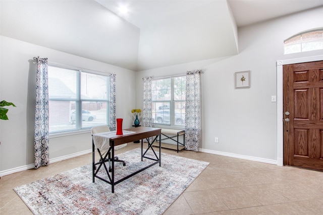 home office with lofted ceiling and light tile patterned flooring