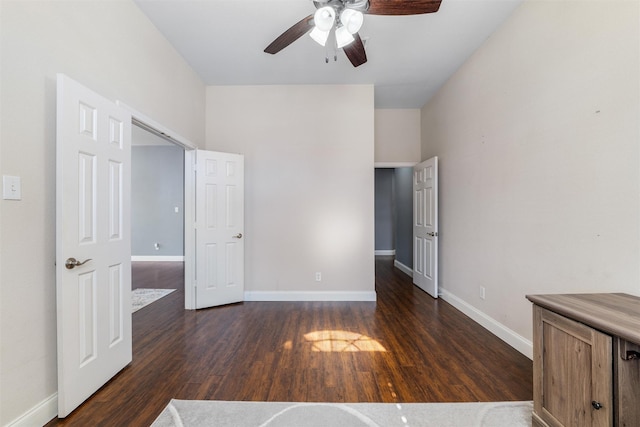 interior space with dark wood-type flooring and ceiling fan