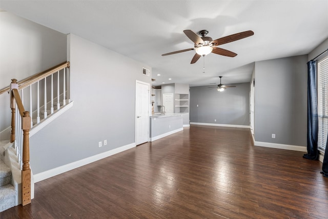 unfurnished living room featuring dark hardwood / wood-style flooring and ceiling fan