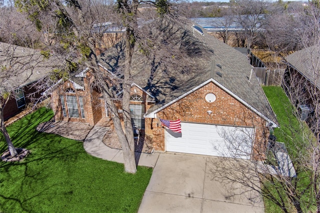 view of front of property featuring a garage and a front lawn