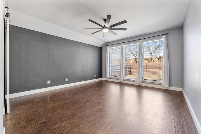 spare room with ceiling fan, dark hardwood / wood-style flooring, and vaulted ceiling