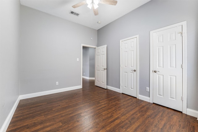 unfurnished bedroom with dark hardwood / wood-style floors and ceiling fan