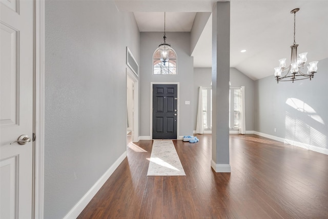 entryway with an inviting chandelier, dark hardwood / wood-style flooring, and a high ceiling