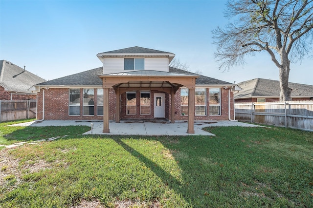 rear view of property with a lawn and a patio