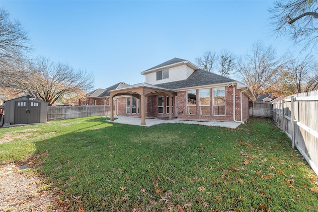 back of house with a lawn, a patio, and a storage unit