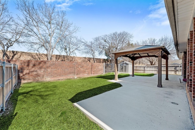 view of yard with a gazebo, a patio area, and a shed