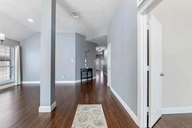 corridor featuring vaulted ceiling and dark hardwood / wood-style floors