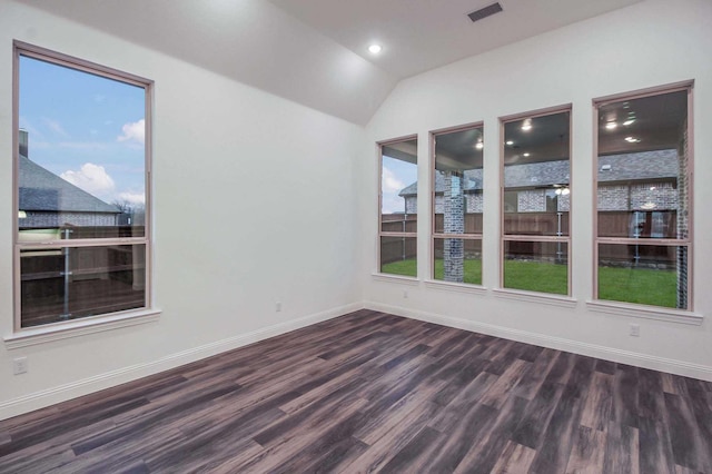 empty room with lofted ceiling and dark wood-type flooring