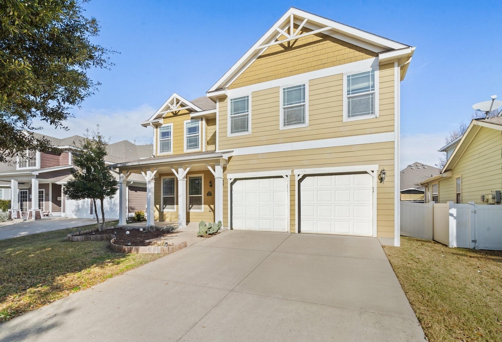 view of front of house featuring a front lawn, covered porch, and a garage