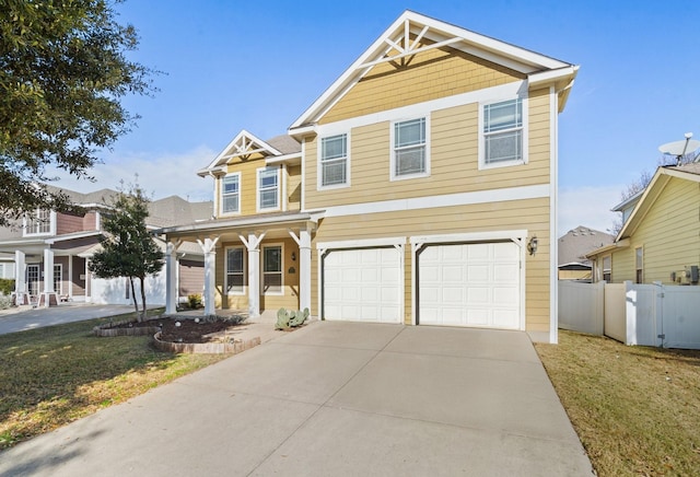 view of front of house featuring a front lawn, covered porch, and a garage