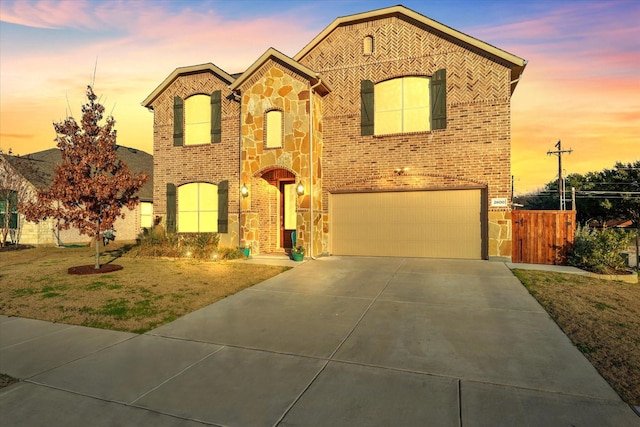 view of front facade with a yard and a garage