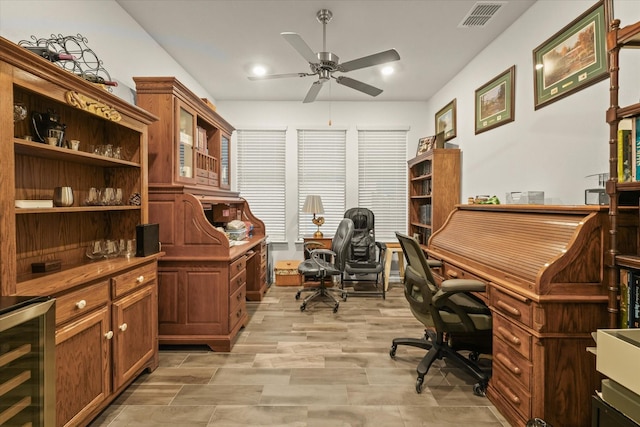 home office with ceiling fan, beverage cooler, and light hardwood / wood-style flooring