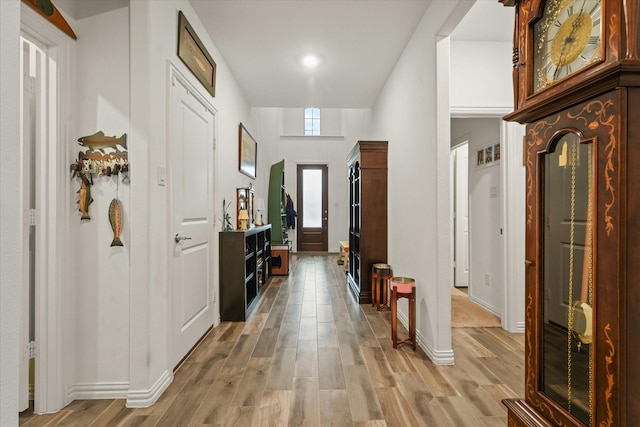 entrance foyer featuring light hardwood / wood-style floors and a towering ceiling