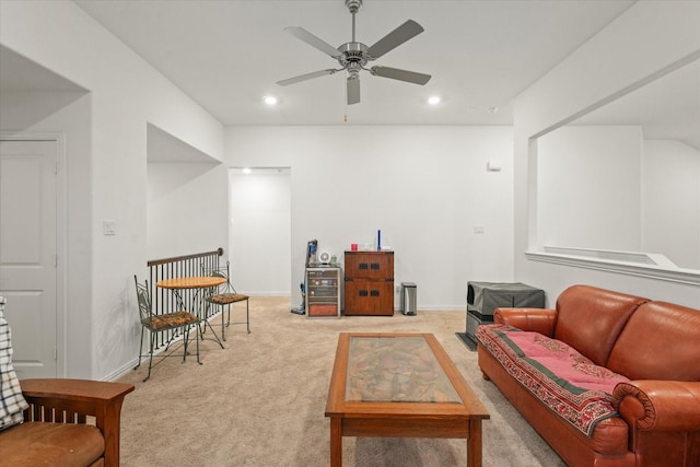 living area featuring ceiling fan and light colored carpet