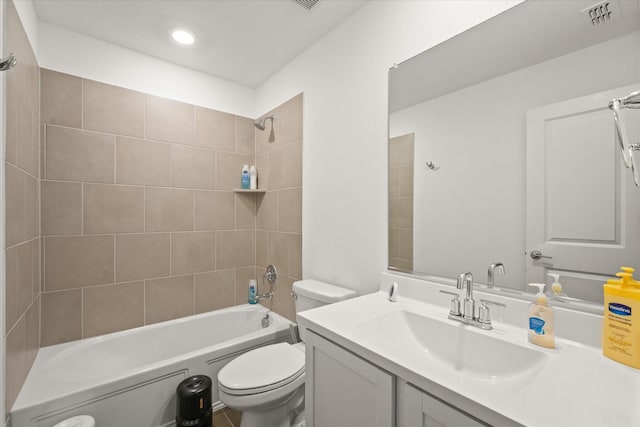 full bathroom featuring toilet, vanity, and tiled shower / bath