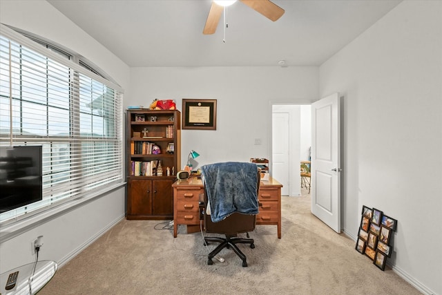 carpeted office featuring ceiling fan