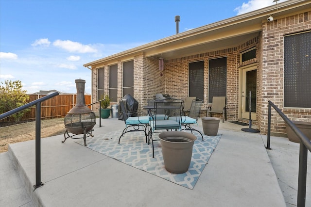 view of patio / terrace featuring an outdoor fire pit