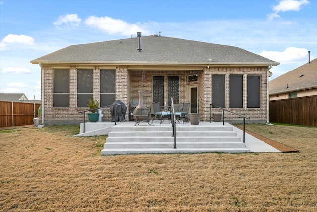 back of house with a patio area and a yard