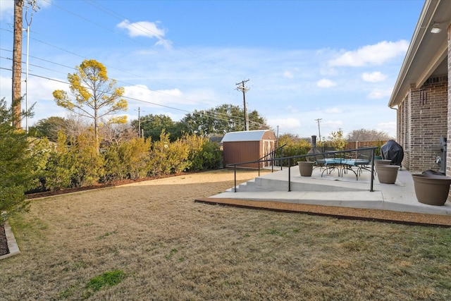 view of yard featuring a shed and a patio