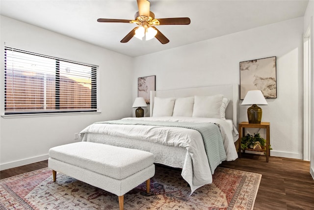 bedroom with ceiling fan and dark hardwood / wood-style floors