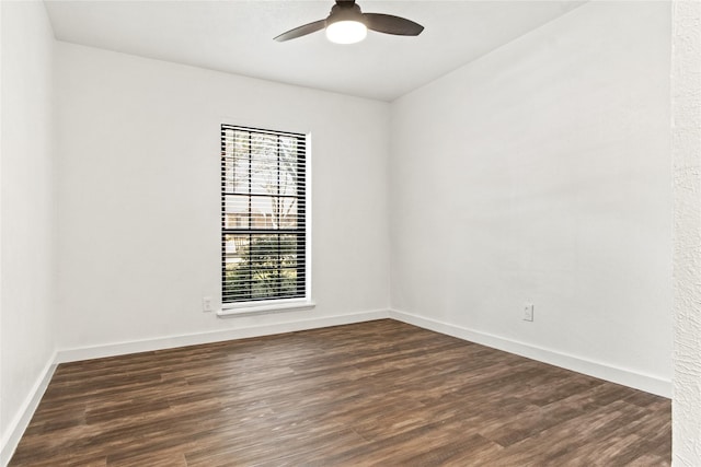 unfurnished room featuring dark wood-type flooring and ceiling fan