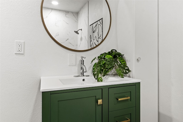 bathroom featuring walk in shower and vanity