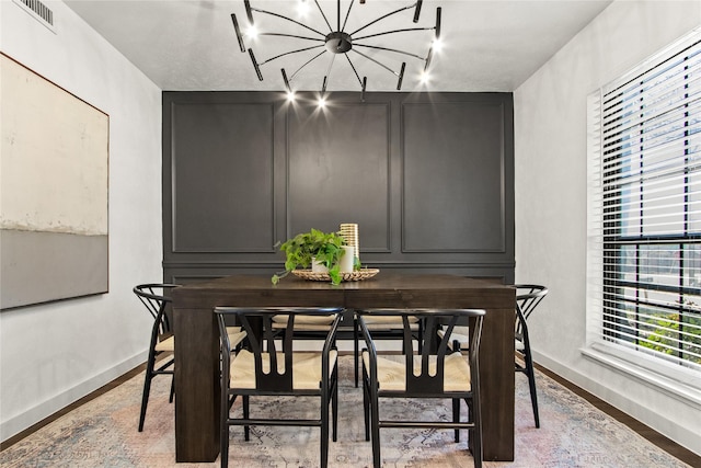 dining room featuring hardwood / wood-style flooring and a notable chandelier