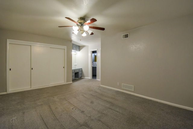 interior space featuring ceiling fan, a closet, carpet floors, and ensuite bath