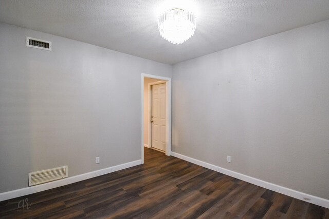 unfurnished living room featuring dark wood-type flooring, ceiling fan, and a brick fireplace