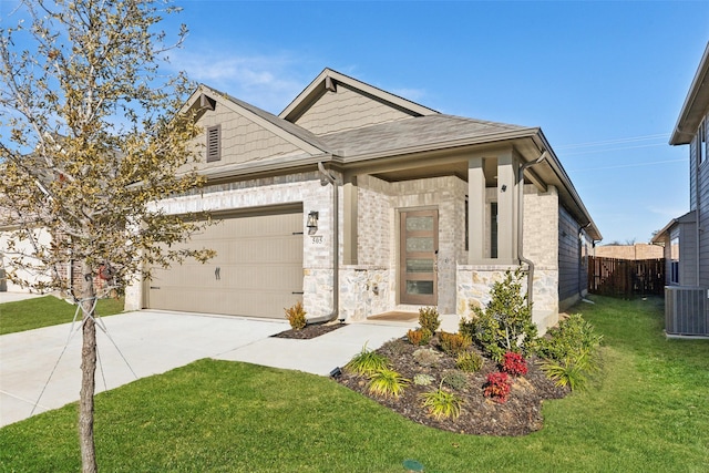 view of front of home featuring a front yard, central AC, and a garage