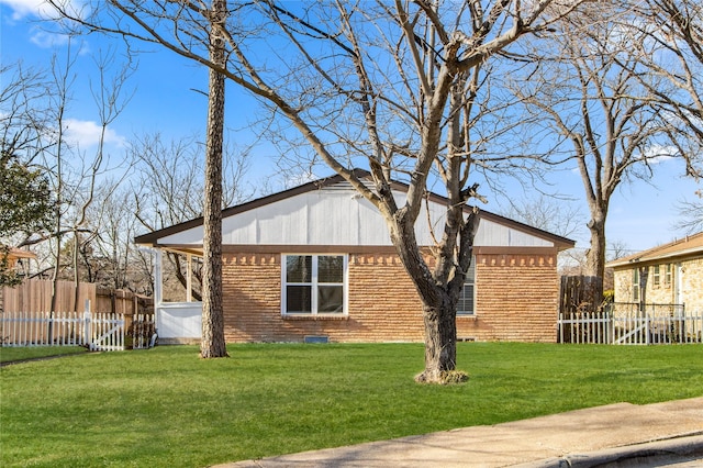 view of side of home with a lawn