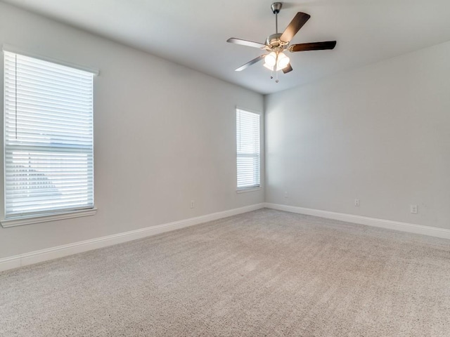 carpeted empty room featuring ceiling fan