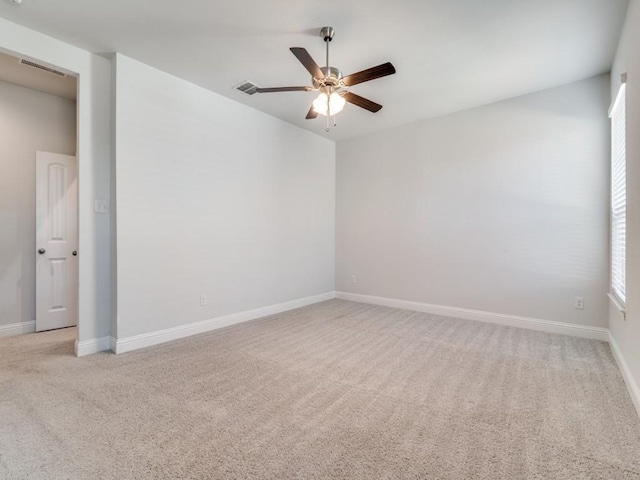 carpeted spare room featuring ceiling fan