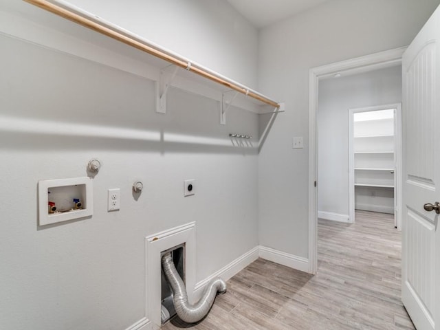 clothes washing area featuring washer hookup, light hardwood / wood-style flooring, hookup for an electric dryer, and hookup for a gas dryer