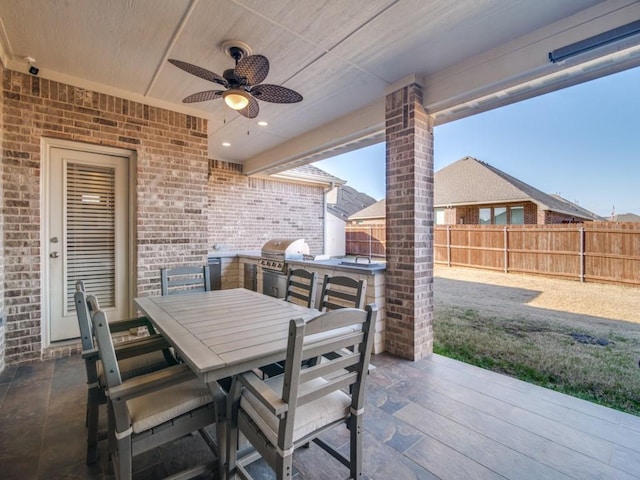 view of patio / terrace featuring ceiling fan, an outdoor kitchen, and area for grilling