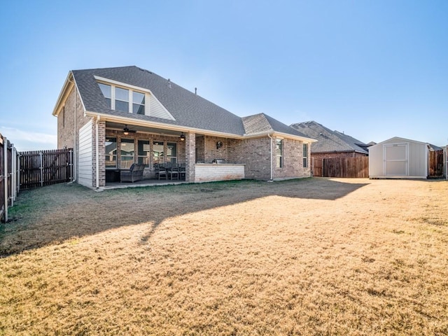 back of property with a patio area, ceiling fan, and a storage unit