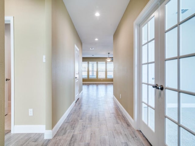 hall featuring french doors and light hardwood / wood-style floors