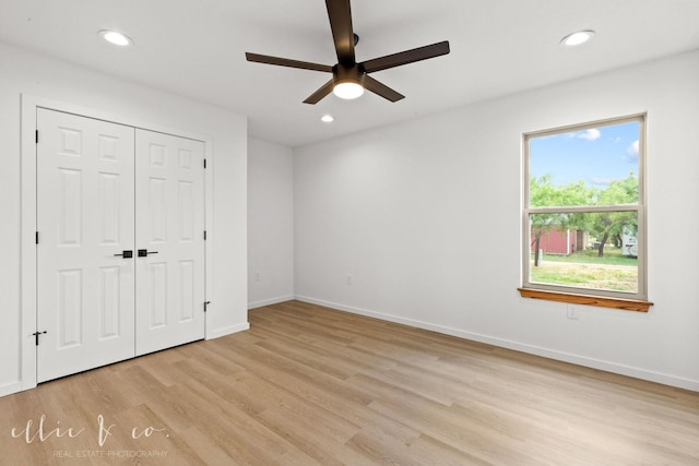 unfurnished bedroom featuring ceiling fan, a closet, and light hardwood / wood-style floors