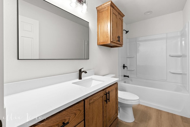 full bathroom with toilet, shower / tub combination, hardwood / wood-style floors, and vanity