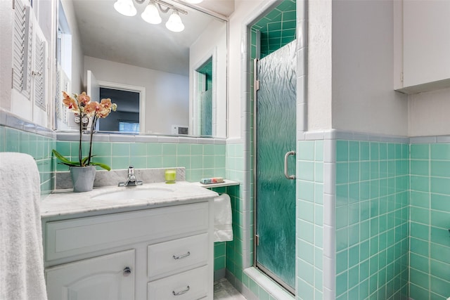 bathroom featuring tile walls, a shower with shower door, and vanity