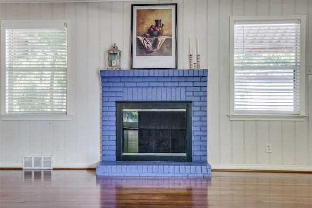 details with hardwood / wood-style floors and a fireplace