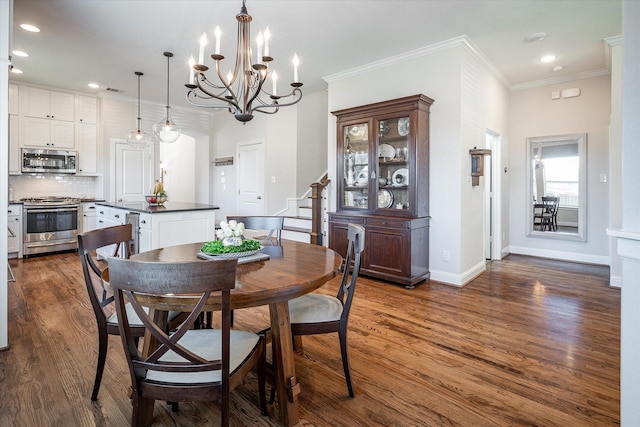 dining space featuring dark wood-type flooring, ornamental molding, and a notable chandelier