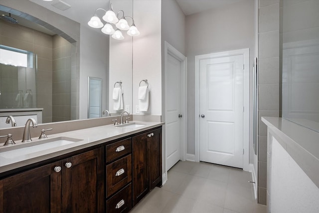 bathroom featuring tiled shower, tile patterned floors, vanity, and a notable chandelier