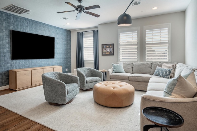 living room with ceiling fan and wood-type flooring